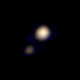 Illustration for article titled Our First Glimpse of Pluto And Charon In Color